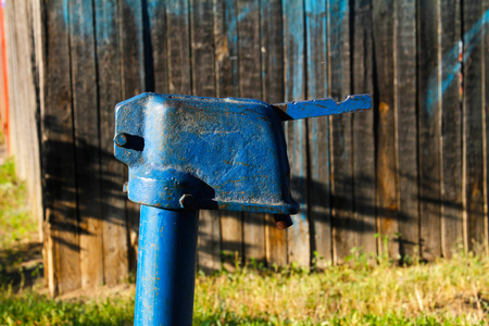 Blue retro water pump in the villageの写真素材