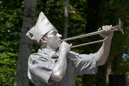 Volgograd, Russia - May 09, 2012: Silver painted artist with horn trumpet dressed as Soviet pioneer on a city streetのeditorial素材