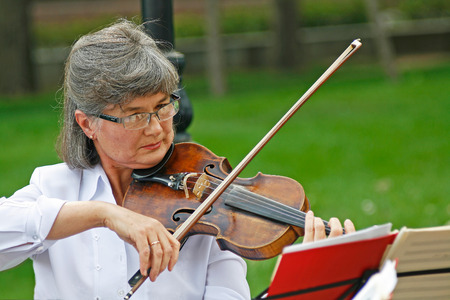 Volgograd, Russia - September 06, 2008: Old woman playing violin in the street in the City Day in Volgogradのeditorial素材