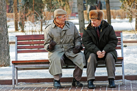 Volgograd, Russia - February 02, 2008: Two older man sitting on the bench in the park and talking in Volgogradのeditorial素材