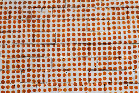 Brown dots on white brick wall as background or texture