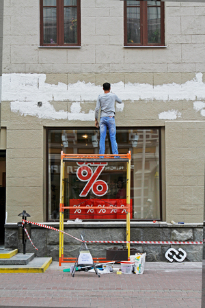 Moscow, Russia - June 30, 2015: Man plastering facade of the building in Moscowのeditorial素材