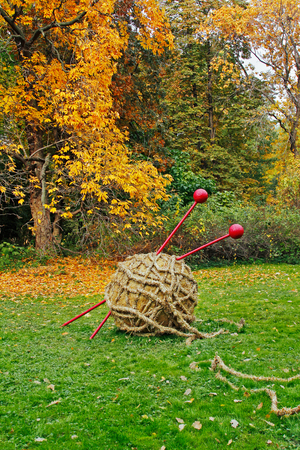 Moscow, Russia - October 03, 2016: Straw ball of yarn and knitting needles in autumn botanical gardenのeditorial素材