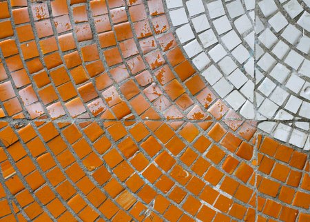Orange and white mosaic tiles on the wall as background or texture