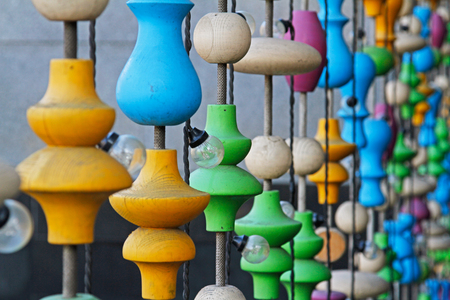Background of different colorful wooden shapes and light bulbs outdoorsの写真素材