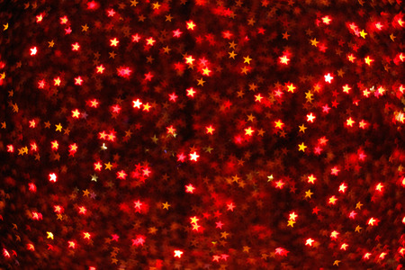 Blurring lights bokeh background of red starsの写真素材