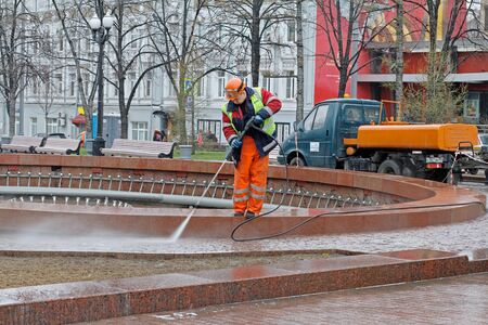 Moscow, Russia - April 13, 2017: Worker cleaning a fountain with pressure washer in Novopushkinsky square in Moscowのeditorial素材