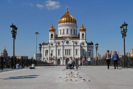 Moscow, Russia - April 12, 2016: Worker mounts illumination on the Patriarch's bridge in front of the Cathedral of Christ the Saviour in Moscowのeditorial素材