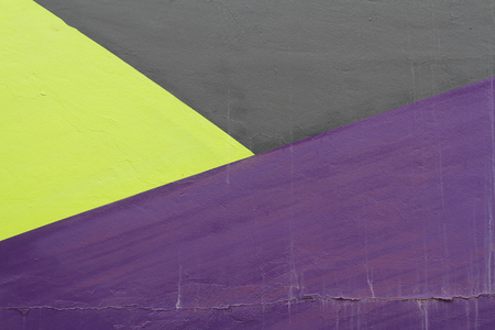 Colorful (black, violet and green) painted wall with cracks as background or textureの写真素材