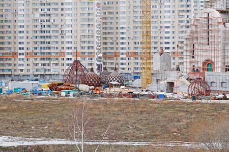 Moscow, Russia - March 15, 2017: Domes of Nikolskaya church under construction on the background of residential buildings in Moscowのeditorial素材