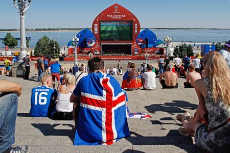 Volgograd, Russia- June 22, 2018: Fan of the national team of Iceland with national flag watching the match at the FIFA Fan Fest on the Central promenade in Volgogradのeditorial素材