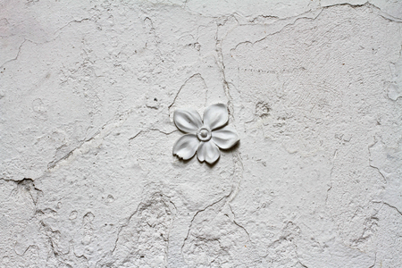 Old white rough wall with gypsum flower as background or textureの写真素材