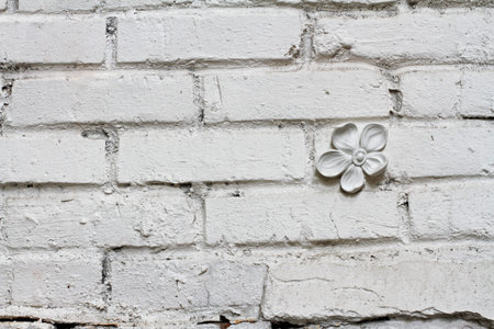 White brick wall with gypsum flower as background or texture