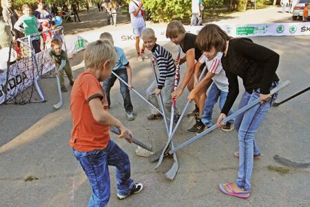 Volgograd, Russia - September 02, 2012: Children playing street hockey on a city holiday in Volgogradのeditorial素材