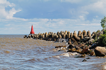 Red navigational signal buoy on the breakwatersの写真素材