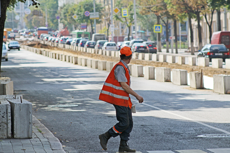 Worker in a special uniform crossing the road in the cityの写真素材