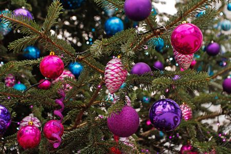 Colorful Christmas toy bumps and balls hanging on Christmas treeの写真素材