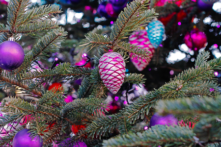 Colorful Christmas toy bumps and balls hanging on Christmas treeの写真素材