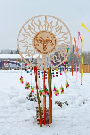 February 18, 2018 - Moscow, Russia: Wooden circle-sun with colorful ribbons at the Russian national festivalのeditorial素材