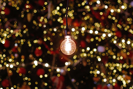 Light bulb in the background of colorful defocused lightsの写真素材