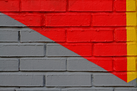 Colorful (yellow, grey and red) brick wall as background, textureの写真素材