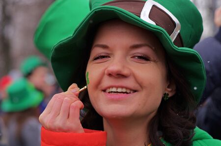 Moscow, Russia-March 24, 2018: Smiling participant in green hat at the St. Patrick's Day Parade in the park Sokolniki in Moscowのeditorial素材