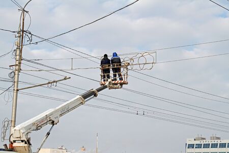 Volgograd, Russia - 28 December, 2018: Workers on the crane install and decorate the Astrakhan bridge with led light in Volgogradのeditorial素材