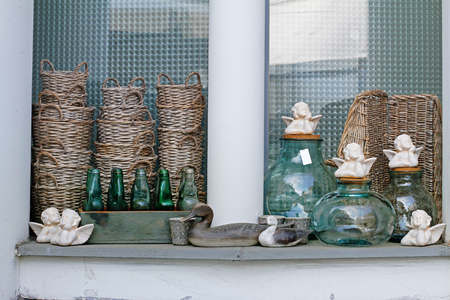 Wooden birds, wicker baskets, ceramic angels, flowerpots, glass bottles and  jars in a flower shoprs in a flower shopの写真素材