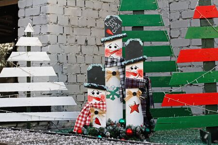 Volgograd, Russia - January 09, 2018: Christmas installation of wooden boards in the form of snowmen and Christmas trees near a cafe in Volgogradのeditorial素材