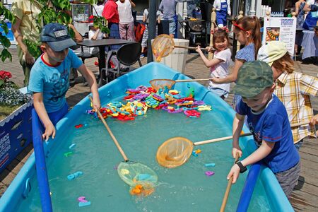 Moscow, Russia - May 29, 2019: Children with butterfly nets catch toys in the boat at the Fish Week festival in Moscowのeditorial素材