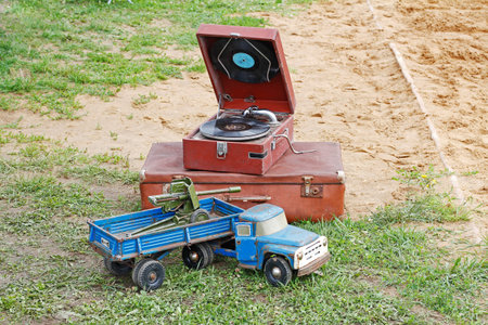 Pushkino, Moscow region, Russia - July 13, 2019: Vintage gramophone, suitcase and toy truck with...