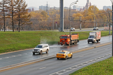 Moscow, Russia - October 20, 2019: Watering machine washes the road dust and dirt in Moscowのeditorial素材