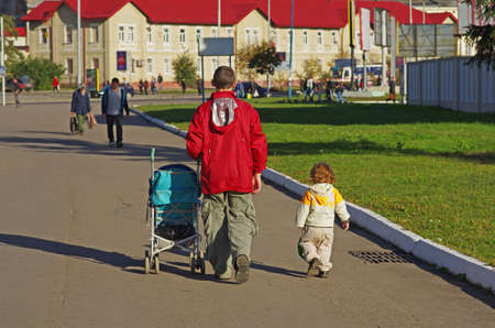 Lviv, Ukraine - October 19, 2012: Dad with a small child walk down the street on a sunny day in Lvivのeditorial素材