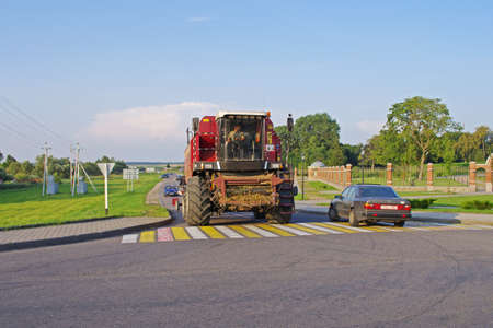 Belarus - August 10, 2013: Combine harvester Palesse GS12 rides on the road in Belarusのeditorial素材