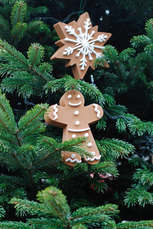 Christmas toy gingerbread man and snowflake hanging on Christmas tree