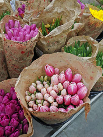Moscow, Russia - March 07, 2020: Bouquets of pink and purple tulips in craft packaging in honor of International Women`s Day in store in Moscowのeditorial素材