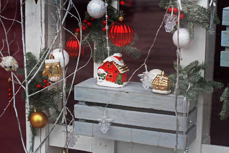 Showcase of shop with different christmas toys and ceramic housesの写真素材