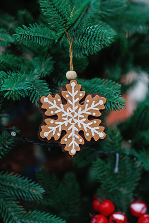 Christmas toy in the form of a snowflake made of felt hanging on the Christmas treeの写真素材