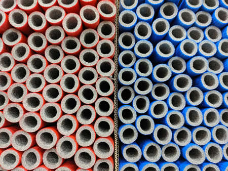 Background or texture of red and blue foam tubes for plumbingの写真素材