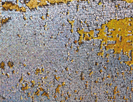 Background or texture of holographic golden and silver sequinsの写真素材
