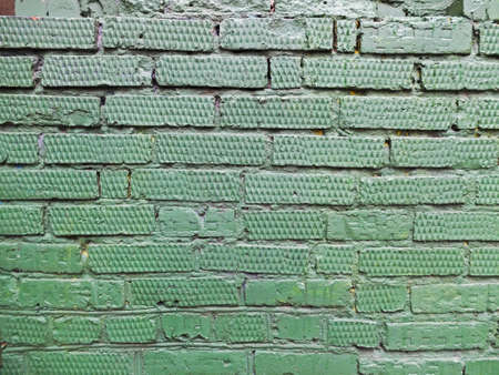 Textured green brick wall as background or textureの写真素材