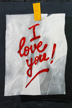 Moscow, Russia - May 20, 2017: Text "I love you!" on paper with stick tape graffiti on black wall background on Flacon Design Factory in Moscowのeditorial素材