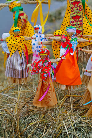 Moscow, Russia - March 12, 2016: Russian Shrovetide small dolls in traditional colorful dresses on the occasion of the arrival of spring in the Park Gorkogoのeditorial素材