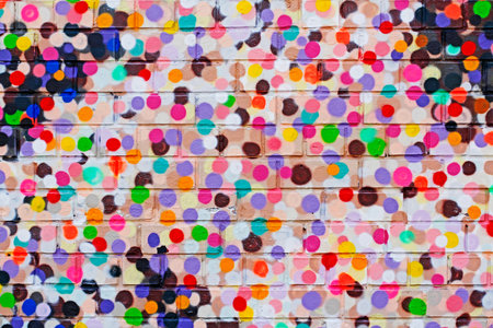 Colorful dots on brick wall as background, textureの写真素材