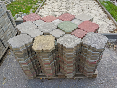 Old dismantled colorful decorative paving slabs on pallet after road repair