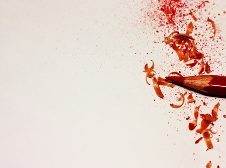 Red Pencil and crayon shavings close-up with place for your text or other design elements.の写真素材