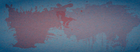 Grunge, scratched blue background with red spots of paint.の写真素材