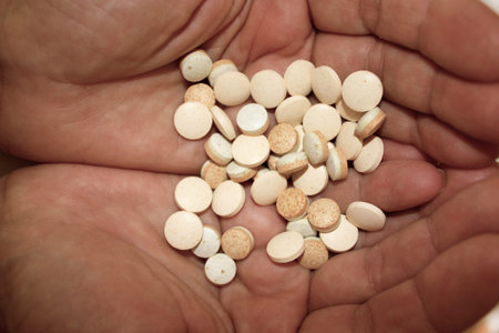 Handful of pills in palms, close-up. Assorted medication in hands. Advertising healthy lifestyle,...