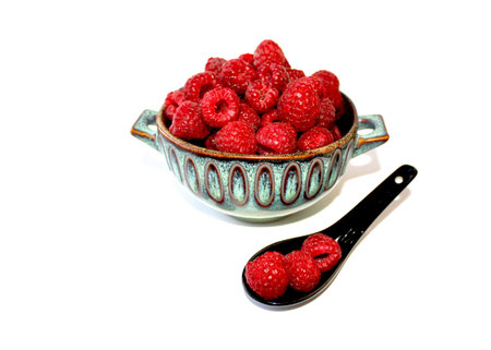 Raspberry in dish. Juicy berries in deep clay plate. Healthy, delicious dessert in beautiful bowl...