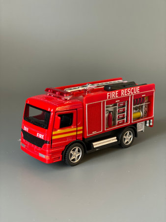 a toy firetruck isolated on a gray background with copy spaceの写真素材